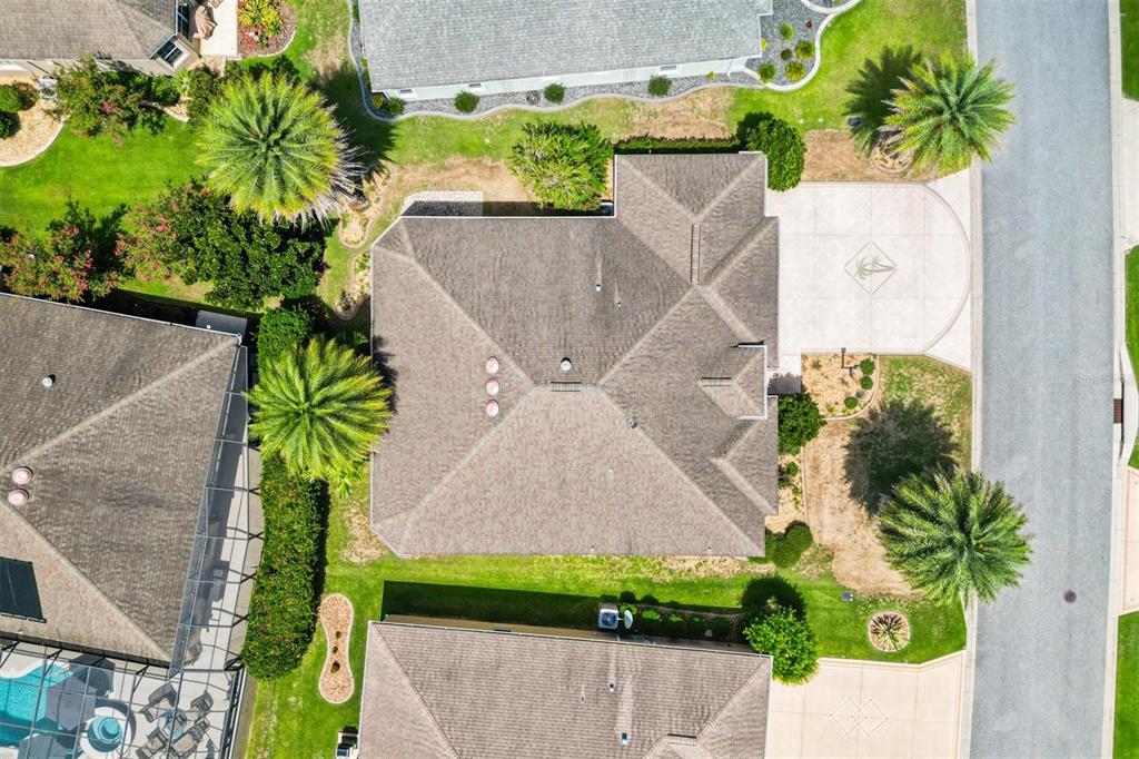 An aerial view shows a residential house with a shingled roof and surrounding landscaping — 1304 BRUNELL STREET, THE VILLAGES, FL