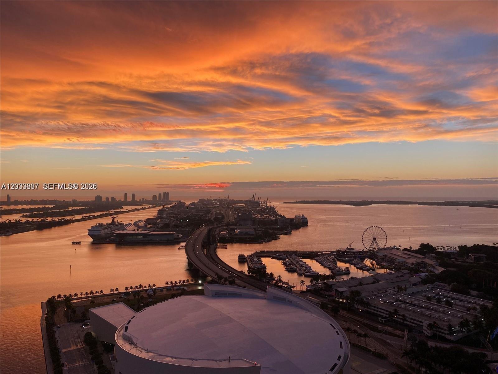 An aerial view shows a bridge, a cruise ship terminal, a marina, and a stadium — 888 Biscayne Blvd # 3001, Miami FL 33132, MIAMI, FL