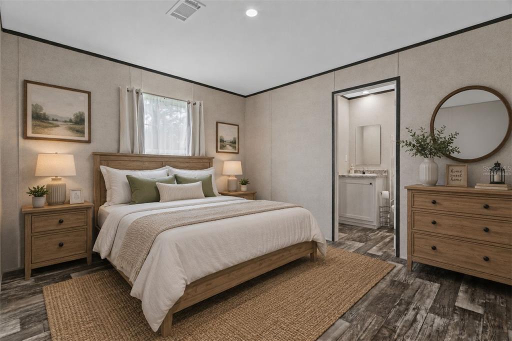 A bedroom features a wooden bed frame, a dresser with a mirror, and an attached bathroom — 4363 CR 690, WEBSTER, FL