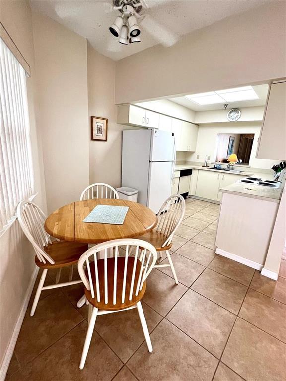 A multi-story beige apartment building with balconies and a central entrance faces a parking lot — 104 SURFVIEW DRIVE UNIT 2503, PALM COAST, FL