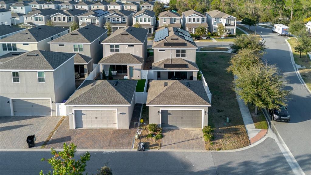 An aerial view shows two suburban houses with attached garages and paved driveways — 16012 MICELLI DRIVE, WINTER GARDEN, FL