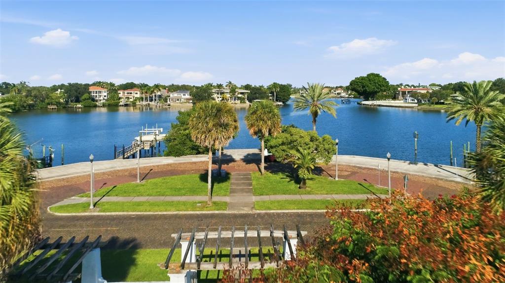 An elevated view of a waterfront park with palm trees, a walkway, and a pergola — 125 23RD AVENUE NE, ST PETERSBURG, FL