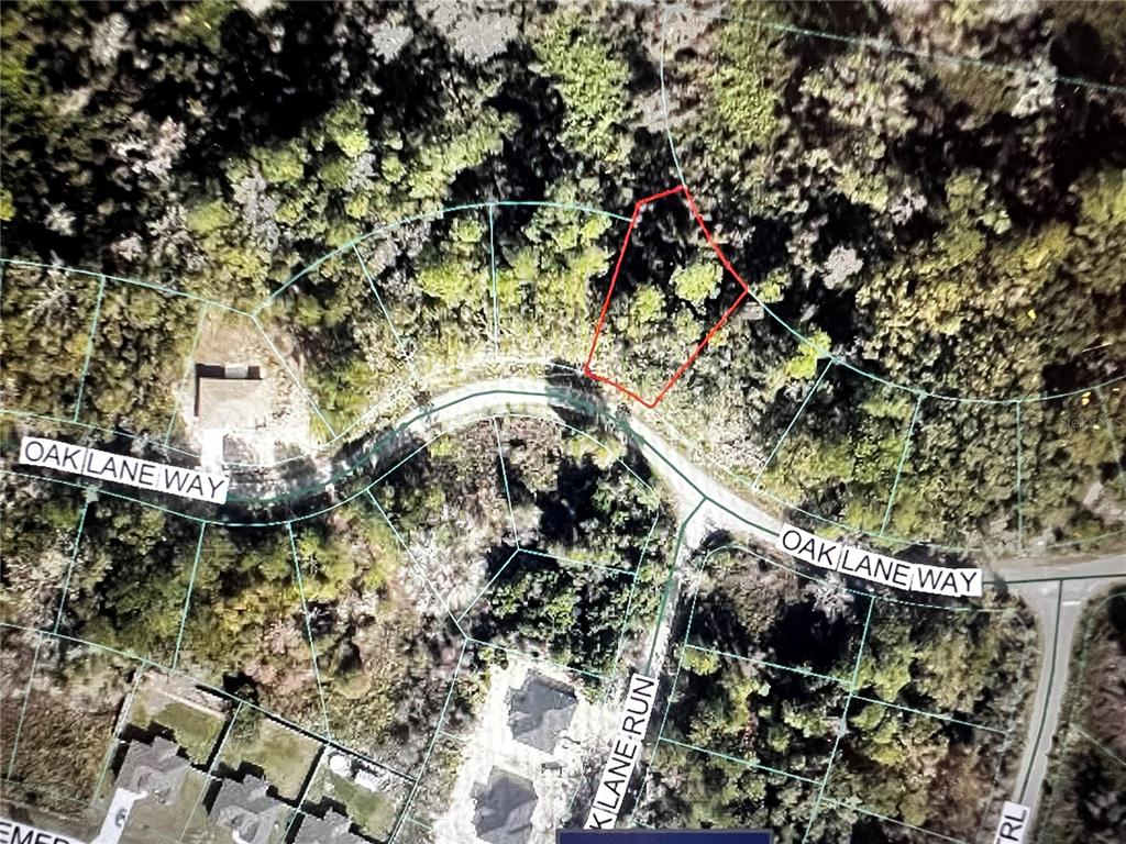 This is an aerial map showing a vacant lot outlined in red on a curved road — 12 OAK LANE WAY, OCALA, FL