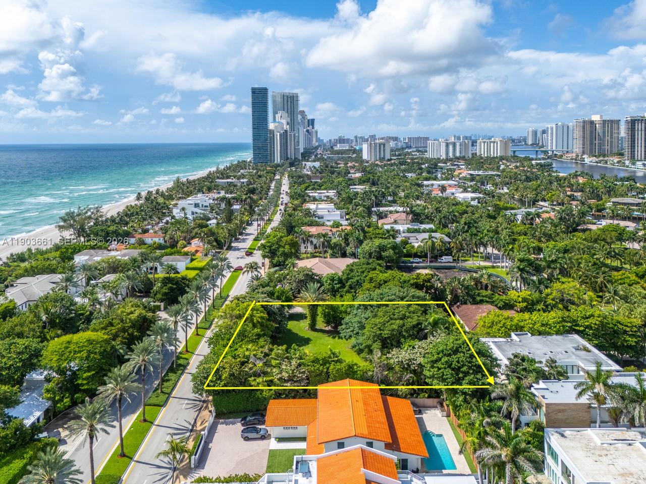 An aerial view shows a rectangular vacant lot surrounded by lush trees and residential buildings — 326 Ocean Blvd, Golden Beach FL 33160, GOLDEN BEACH, FL