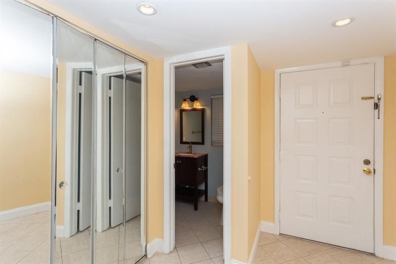 A hallway features mirrored closet doors, a doorway to a bathroom, and a white door — 5200 Lake Loop Road, Cooper City FL 33330, COOPER CITY, FL