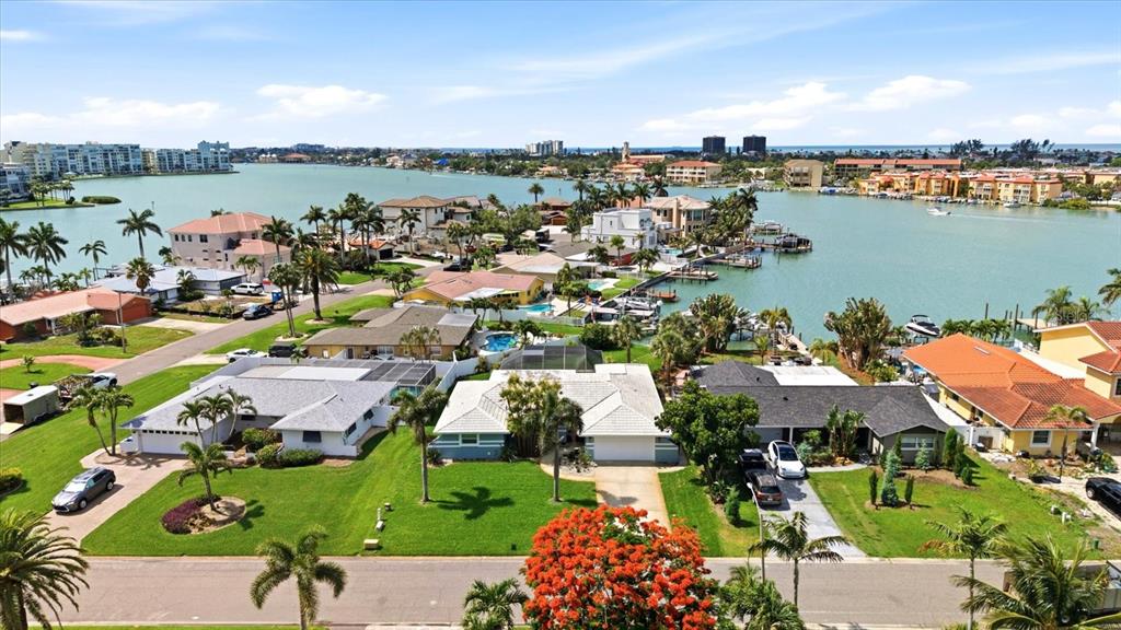 An aerial view shows waterfront houses with pools and docks along a bay — 8008 13TH AVENUE S, ST PETERSBURG, FL