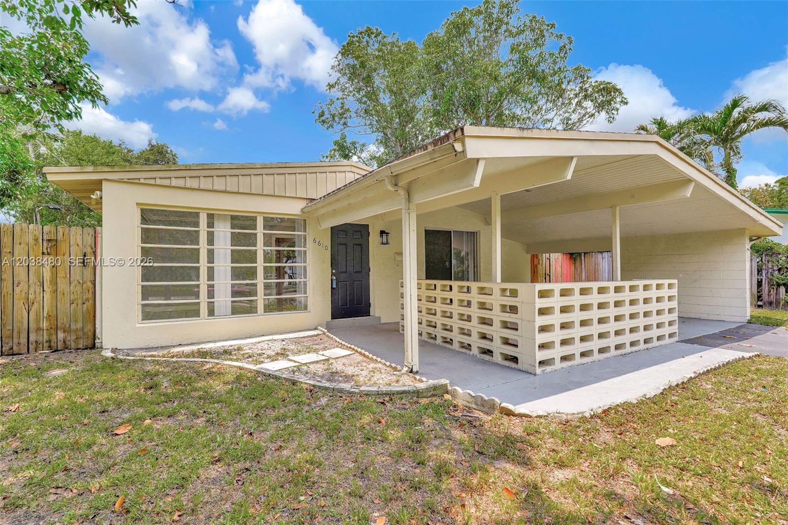 A single-story house features a covered porch with a decorative concrete block wall — 6610 Johnson St, Hollywood FL 33024, HOLLYWOOD, FL