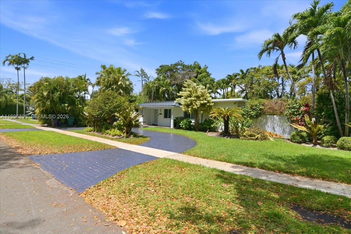 A single-story house with a dark driveway sits on a grassy lot with palm trees — 6133 SW 44th Ter, Miami FL 33155, MIAMI, FL