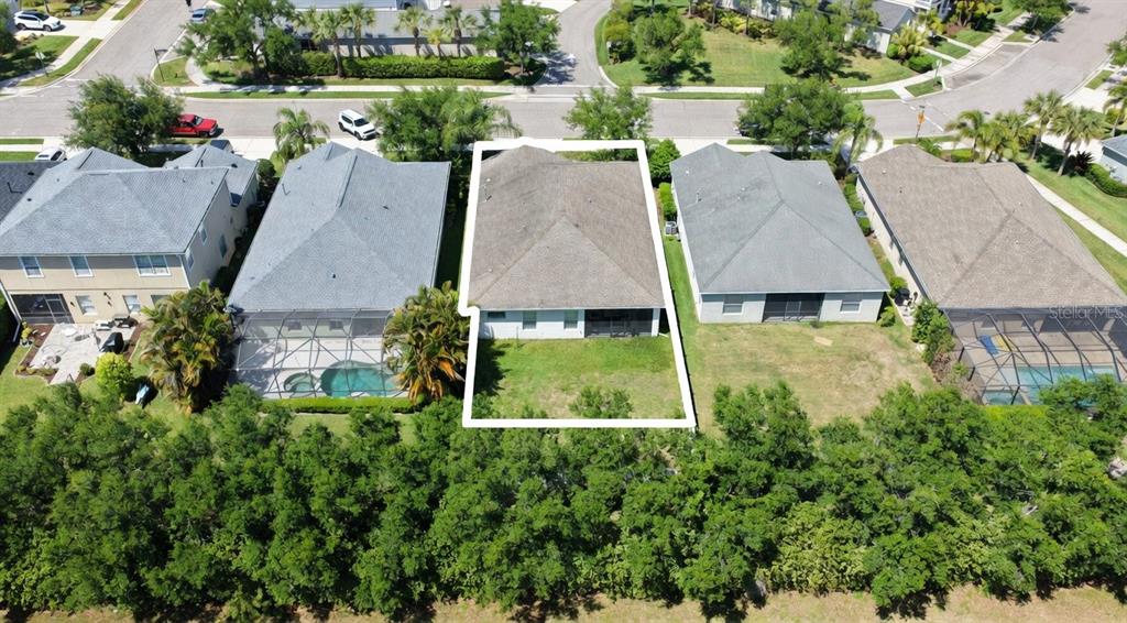 An aerial view shows a residential house with a fenced backyard and a screened porch — 4650 WOODBROOK DRIVE, SARASOTA, FL