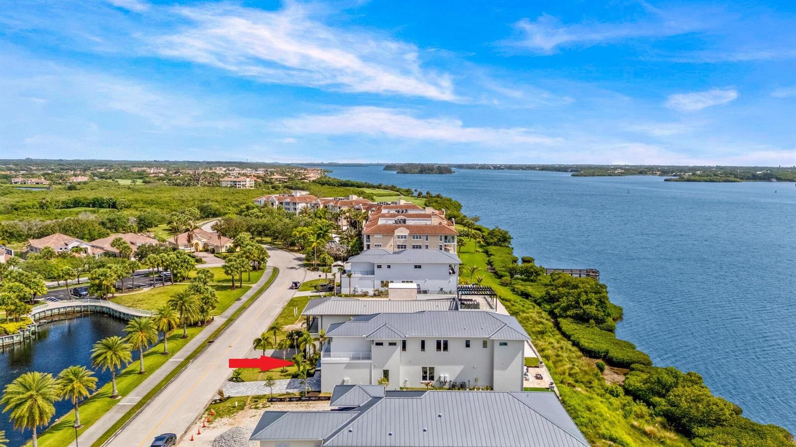 An aerial view of a waterfront residential neighborhood with a red arrow pointing toward a house — 4842 S Harbor Drive, Vero Beach FL 32967, VERO BEACH, FL