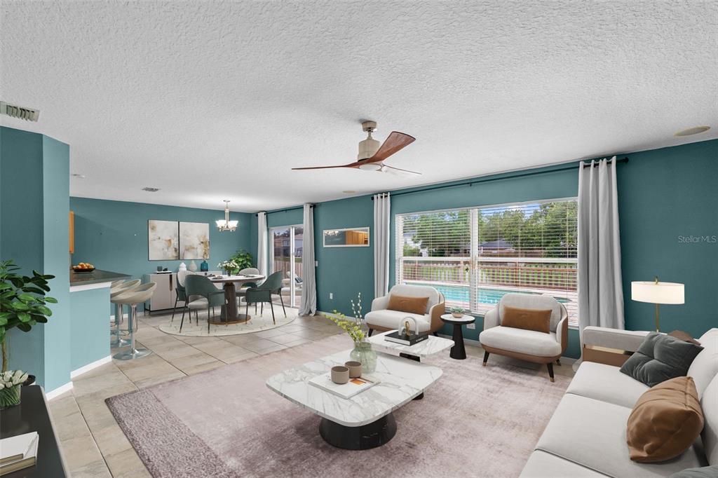 A two-story stucco house features a palm tree, a front garden, and a blue door — 11913 MANGO GROVES BOULEVARD, SEFFNER, FL