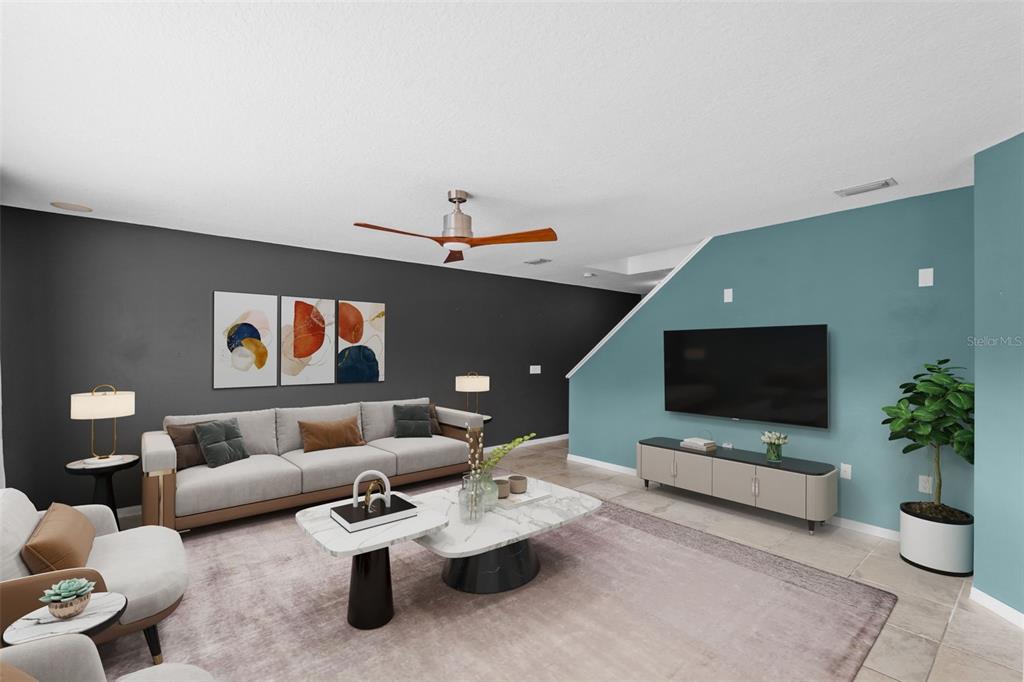 An open-concept living and dining area features teal walls, tile flooring, and a backyard pool — 11913 MANGO GROVES BOULEVARD, SEFFNER, FL