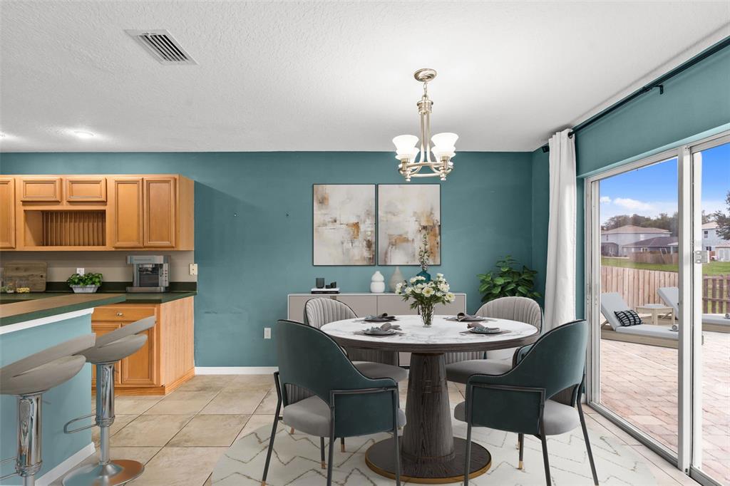 A living room features a gray accent wall, a teal wall, and a marble coffee table — 11913 MANGO GROVES BOULEVARD, SEFFNER, FL