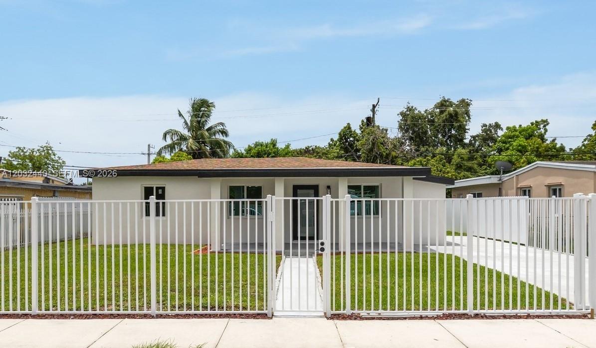 A single-story house with a white exterior and a white metal fence in the front — 3260 NW 95th Ter, Miami FL 33147, MIAMI, FL