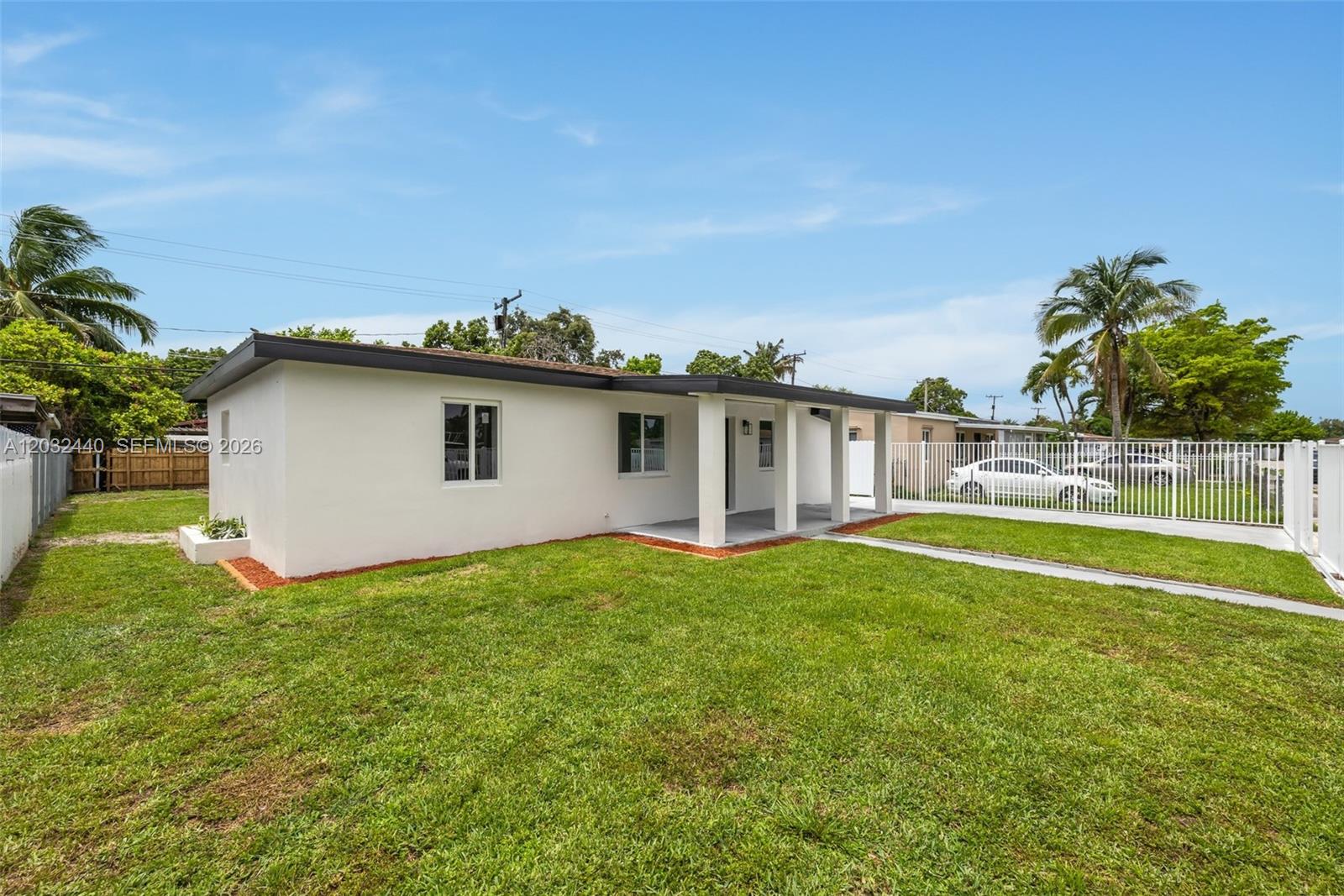 A white, single-story house with a flat roof and a covered front porch — 3260 NW 95th Ter, Miami FL 33147, MIAMI, FL