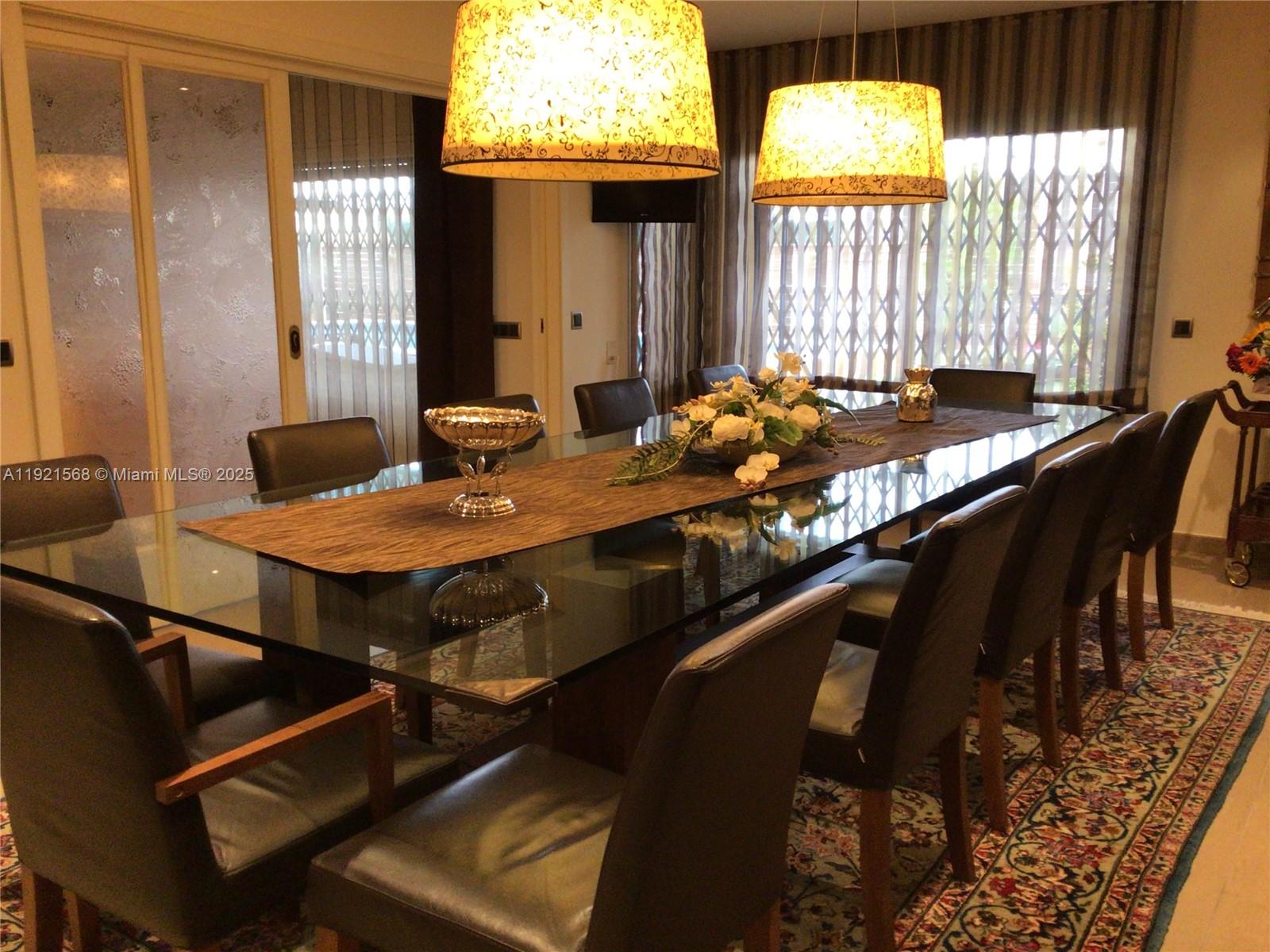 A dining room features a glass-topped table, dark leather chairs, and two patterned pendant lights — 17 Canonge Domenech, PA 17310, PA