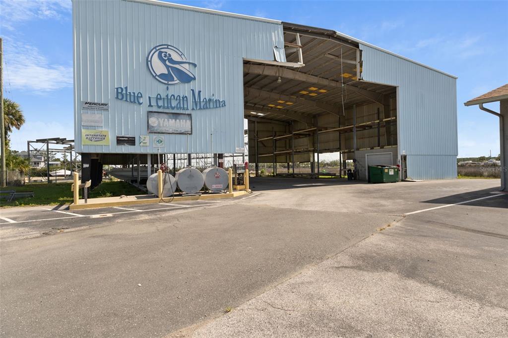 The exterior of a large metal marina building features a prominent pelican logo and signage — 4984 CALIENTA STREET, HERNANDO BEACH, FL