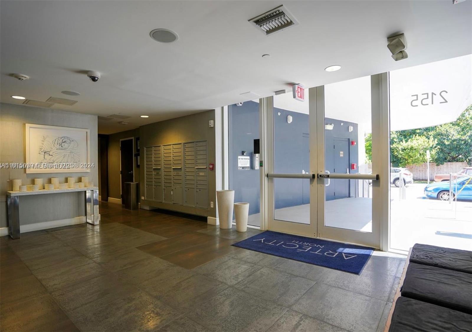 A building lobby features tile floors, a wall of mailboxes, and glass entry doors — 2155 Washington Ct # 206, Miami Beach FL 33139, MIAMI BEACH, FL