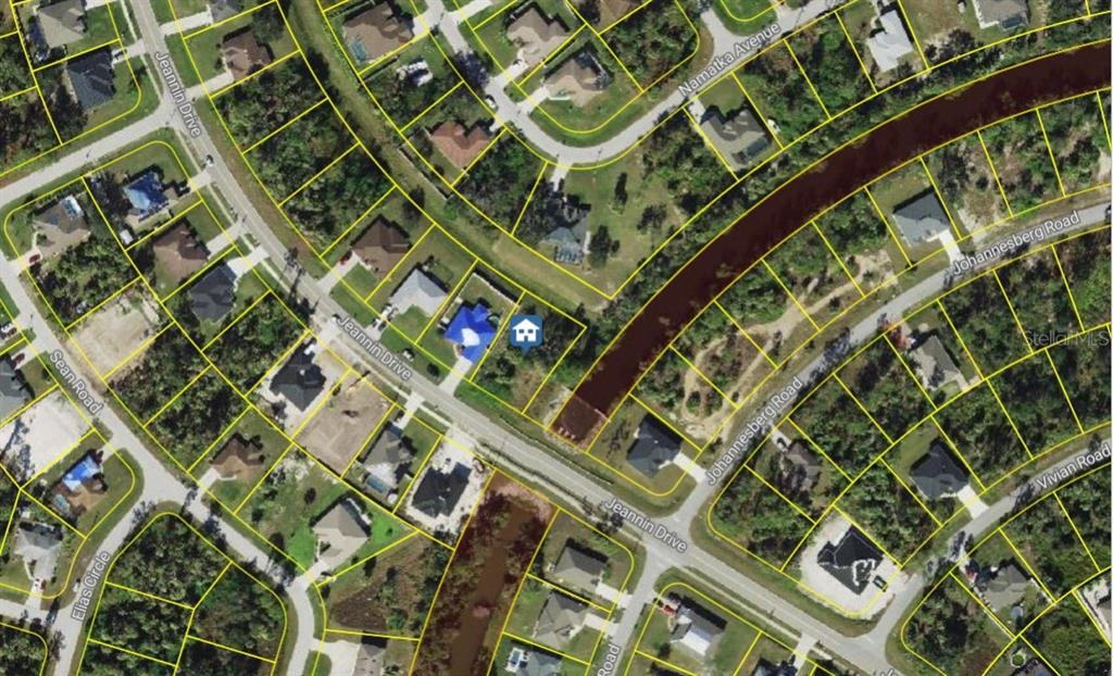 This is an aerial map view showing a residential property highlighted among surrounding houses and streets — Lot#26 JEANNIN DRIVE, NORTH PORT, FL