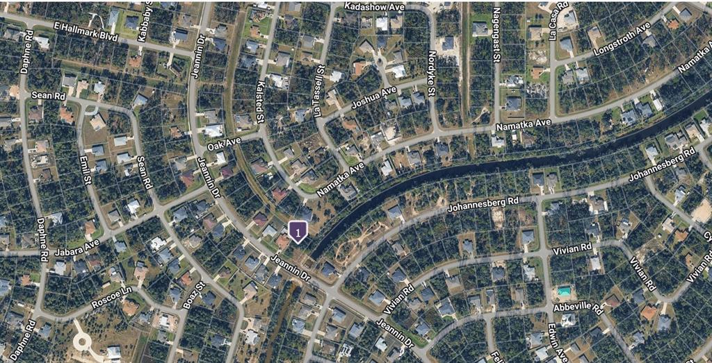 This is an aerial map view of a residential neighborhood with houses and streets — Lot#26 JEANNIN DRIVE, NORTH PORT, FL