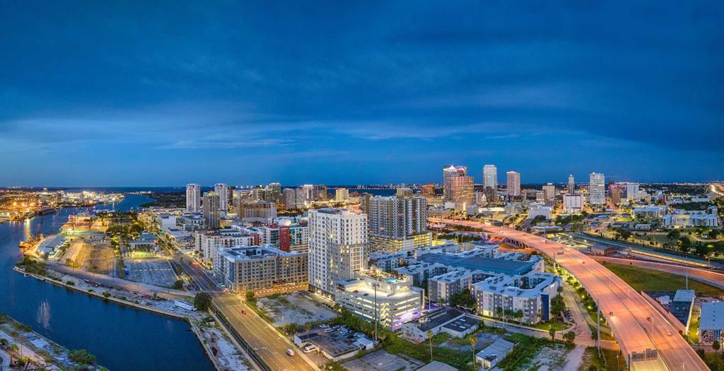 An aerial view of a city skyline at dusk with a highway and waterfront — 601 N 12TH STREET N UNIT A2, TAMPA, FL