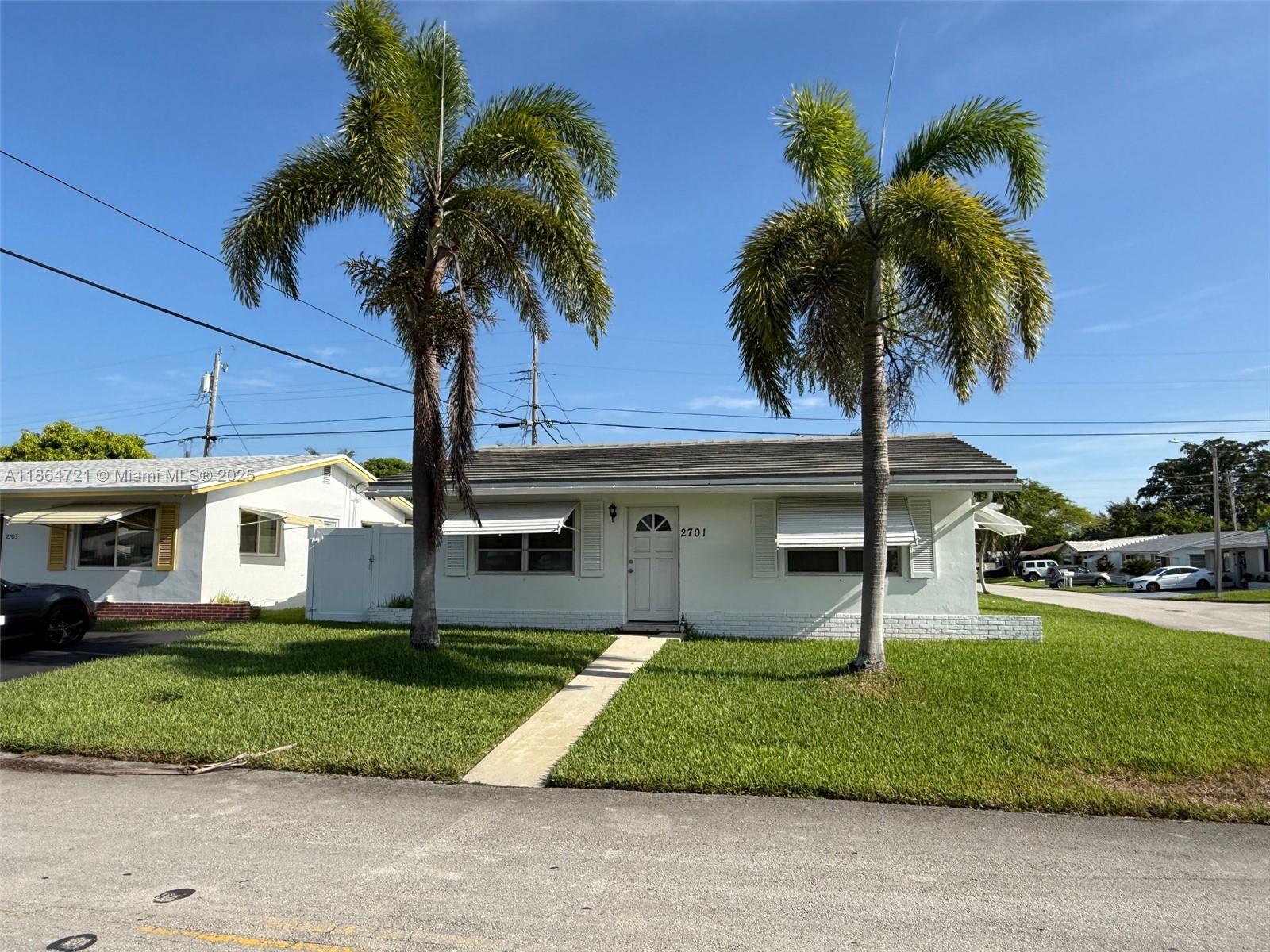 A single-story white house with two palm trees in the front yard — 2701 NW 52nd Ct, Tamarac FL 33309, TAMARAC, FL