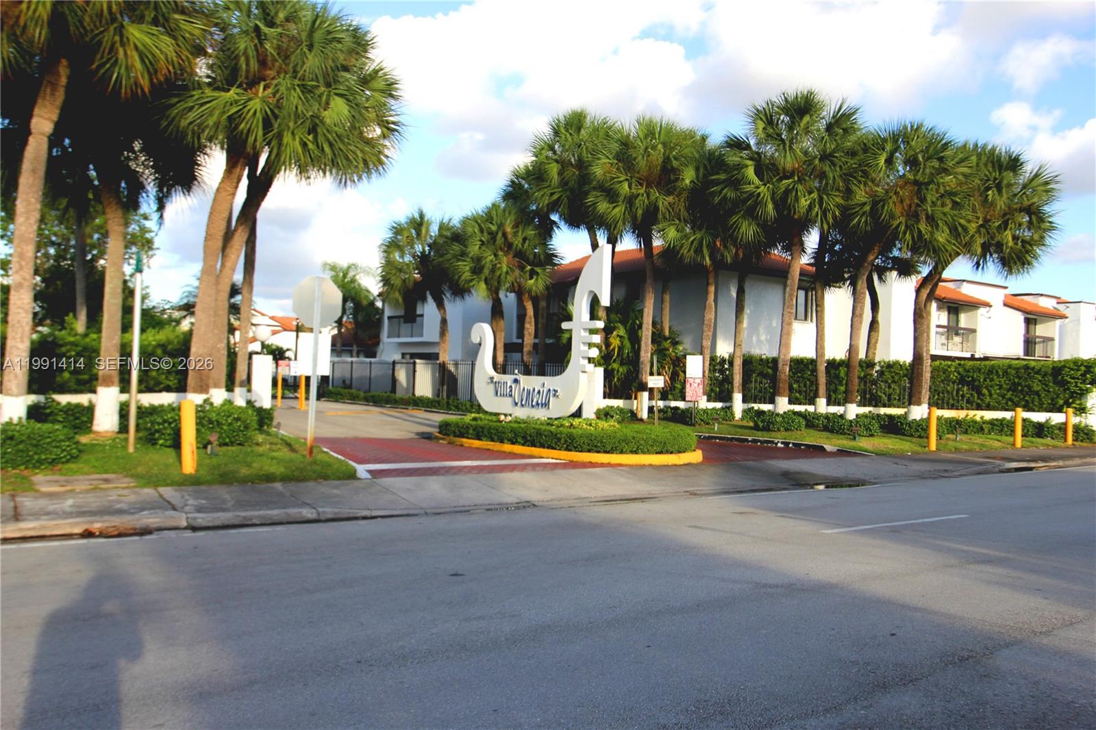 The entrance to the Villa Venezia residential complex features a gondola-shaped sign and palm trees — 1221 SW 124th Ct, Miami FL 33184, MIAMI, FL