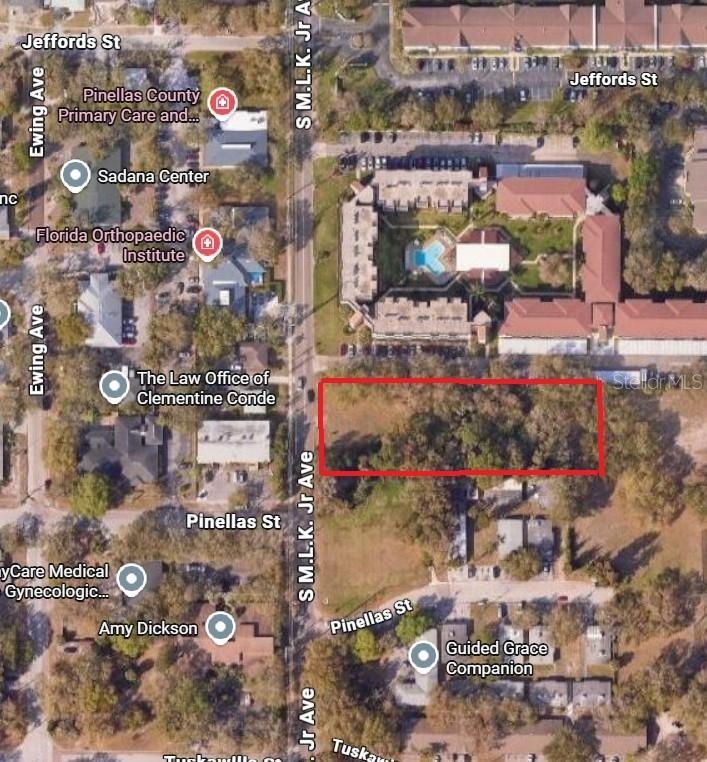 This aerial map shows a vacant, wooded lot outlined in red near a city street — S MARTIN LUTHER KING JR AVENUE, CLEARWATER, FL