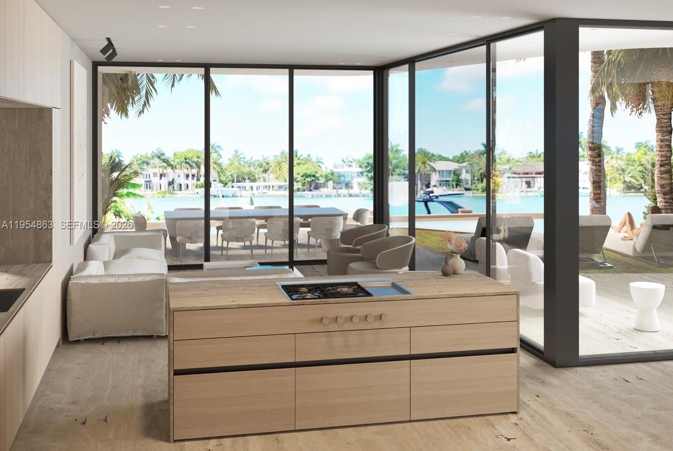 This rendering shows a modern kitchen island with a cooktop overlooking a waterfront patio — 80 S Hibiscus Dr, Miami Beach FL 33139, MIAMI BEACH, FL