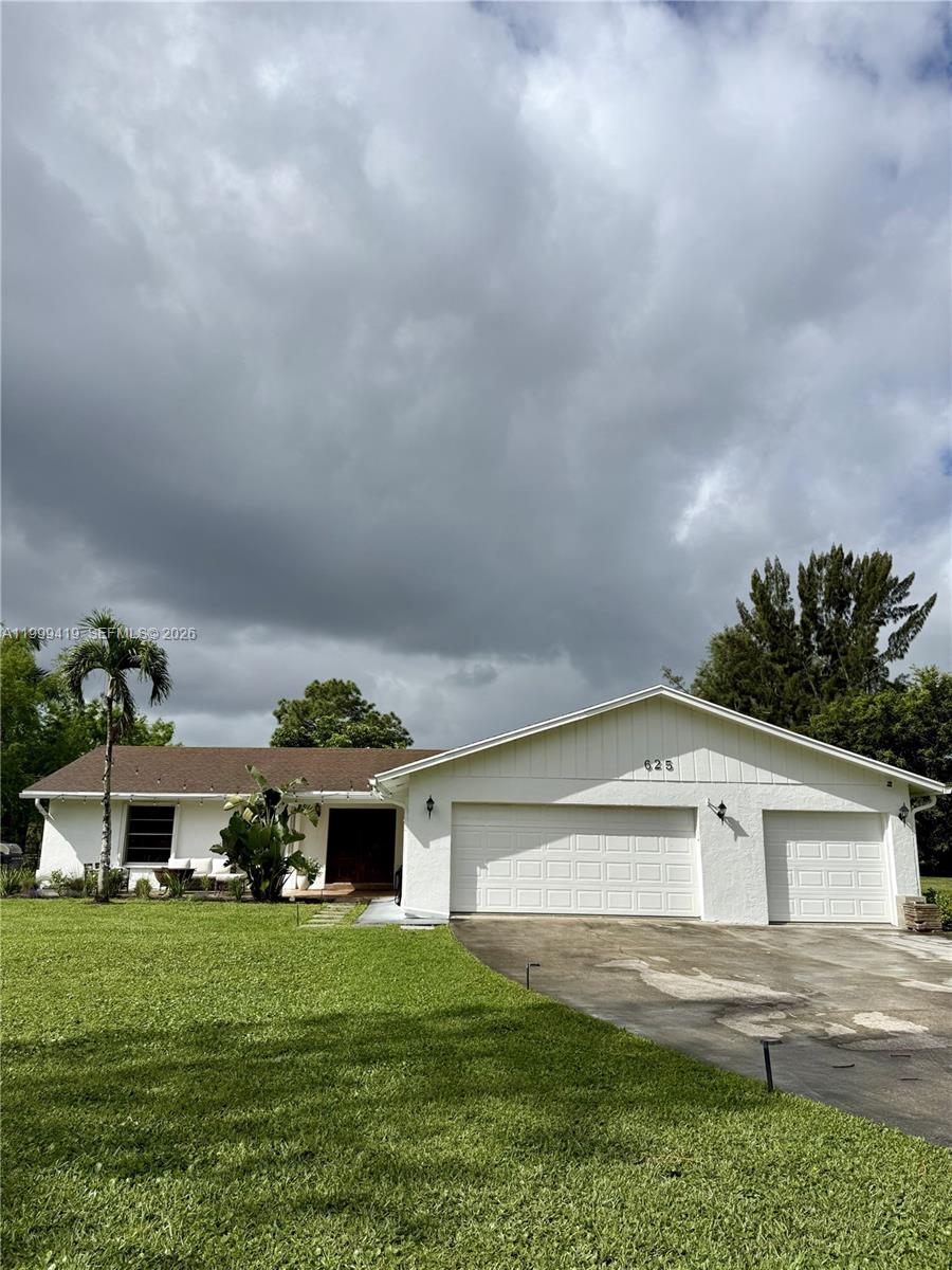 A single-story white house with a brown roof and a three-car garage — 625 Whippoorwill Ter, West Palm Beach FL 33411, WEST PALM BEACH, FL