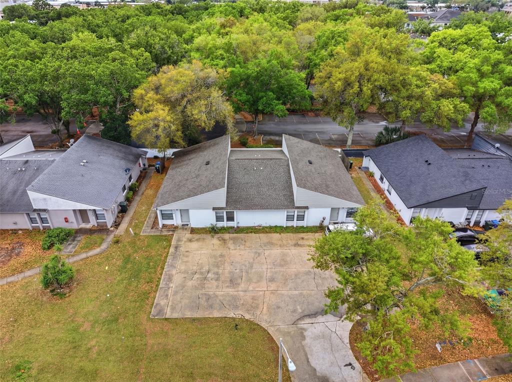 An aerial view shows three single-story residential buildings with gray roofs and a shared concrete driveway — 1912-1918 CRYSTAL GROVE DRIVE, LAKELAND, FL