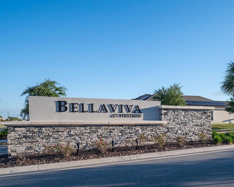 A stone and concrete monument sign displays the name Bellaviva at Westside — 9418 WESTSIDE HILLS DRIVE, DAVENPORT, FL
