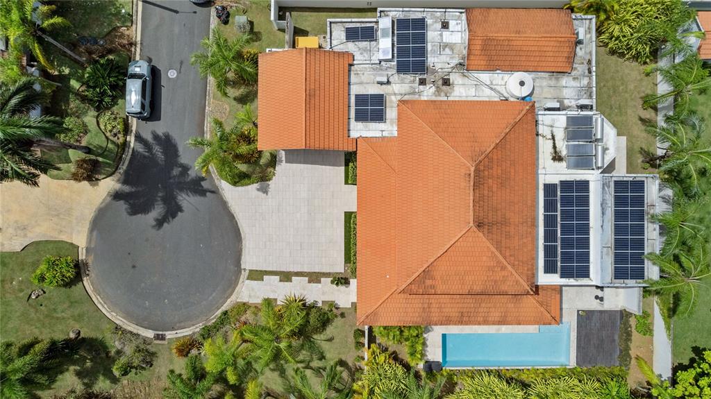An aerial view shows a house with a tiled roof, solar panels, and a swimming pool — Sabanera Dorado CAMINO DEL FLAMBOYAN STREET UNIT 247, DORADO, PR