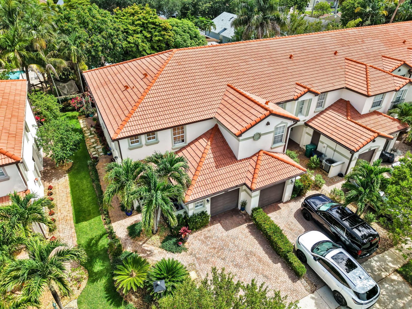 An aerial view of a two-story townhouse with a red tile roof and driveway — 9731 Darlington Place, Cooper City FL 33328, COOPER CITY, FL