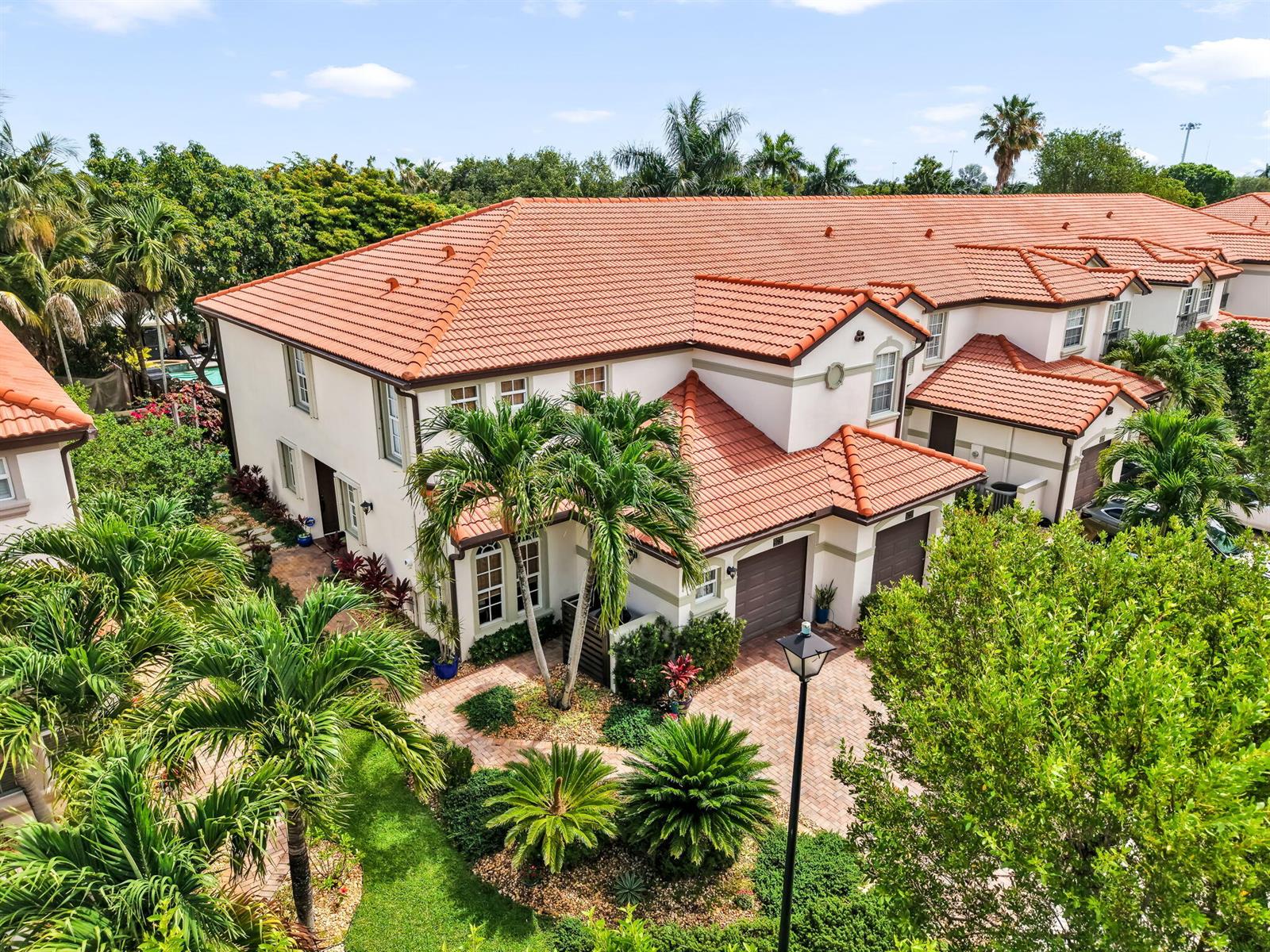 An aerial view of a two-story townhouse with a red tile roof and palm trees — 9731 Darlington Place, Cooper City FL 33328, COOPER CITY, FL