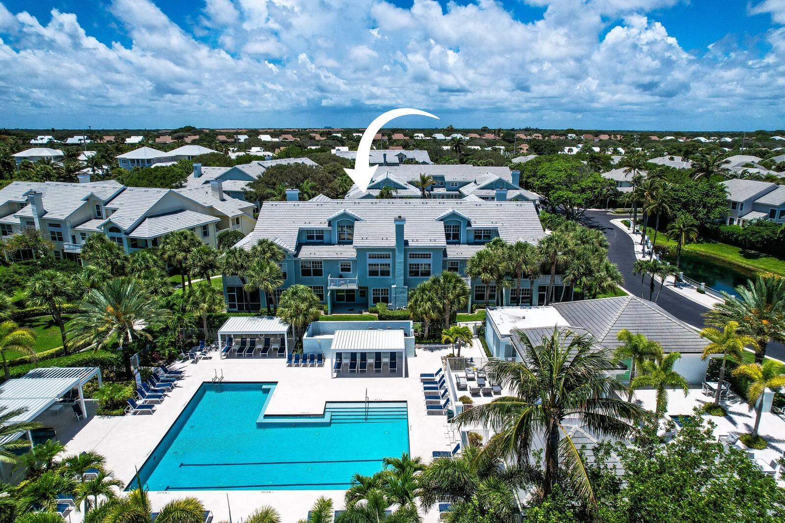 An aerial view of a multi-story residential building with a swimming pool in the foreground — 1506 Mizzenmast Way, Jupiter FL 33477, JUPITER, FL