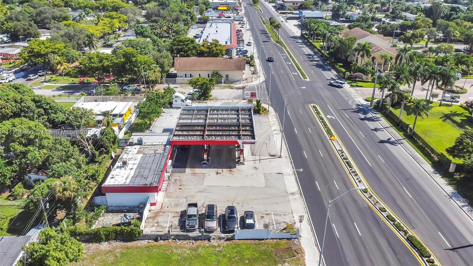 An aerial view shows a gas station with a canopy, convenience store, and parking lot — 1601 NW 119 St, North Miami FL 33167, NORTH MIAMI, FL