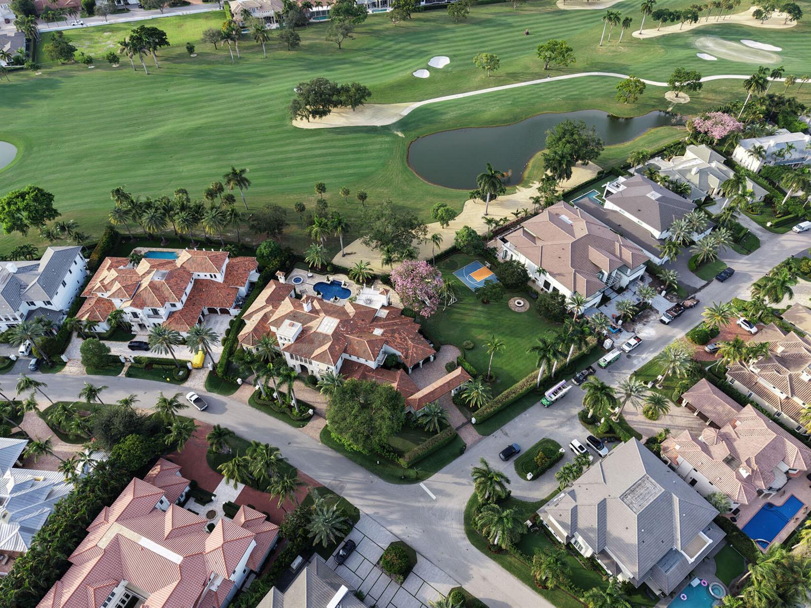 An aerial view shows several large houses with tile roofs, swimming pools, and a golf course — 1869 Sabal Palm Drive, Boca Raton FL 33432, BOCA RATON, FL