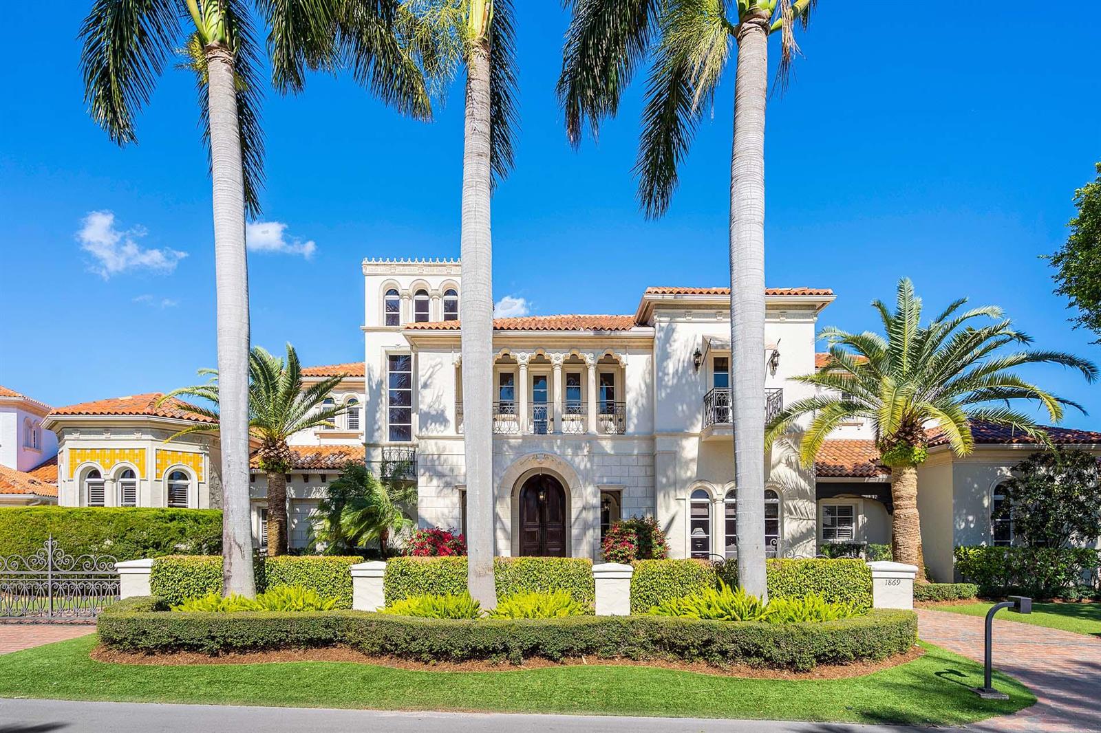 A large Mediterranean-style house with a tile roof, arched entryway, and tall palm trees — 1869 Sabal Palm Drive, Boca Raton FL 33432, BOCA RATON, FL