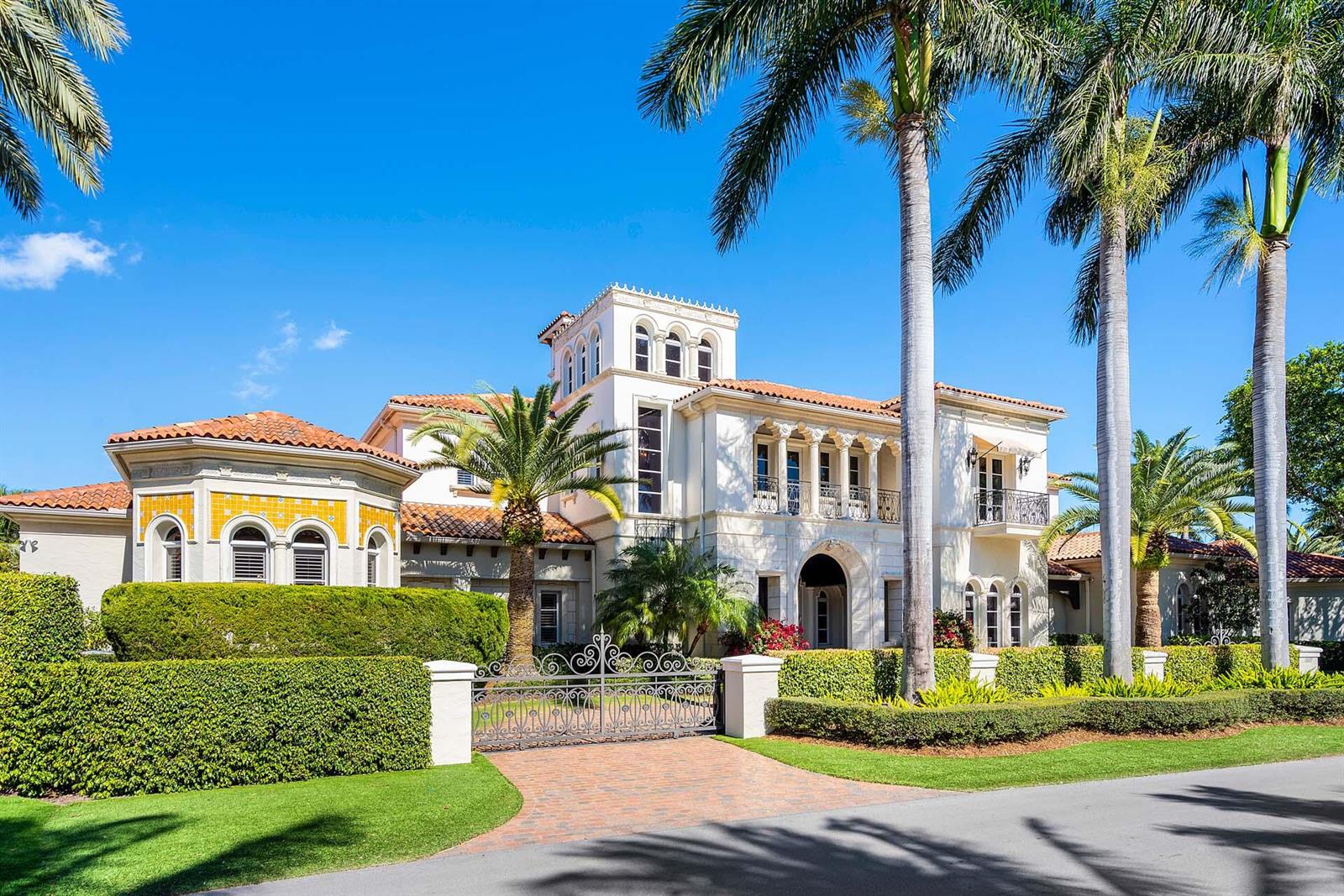 A large Mediterranean-style mansion with a gated driveway, palm trees, and manicured hedges — 1869 Sabal Palm Drive, Boca Raton FL 33432, BOCA RATON, FL