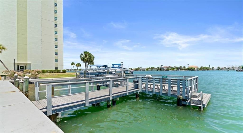 An aerial view of a sandy beach with resort buildings, swimming pools, and water slides — 400 64TH AVENUE UNIT 405, ST PETE BEACH, FL