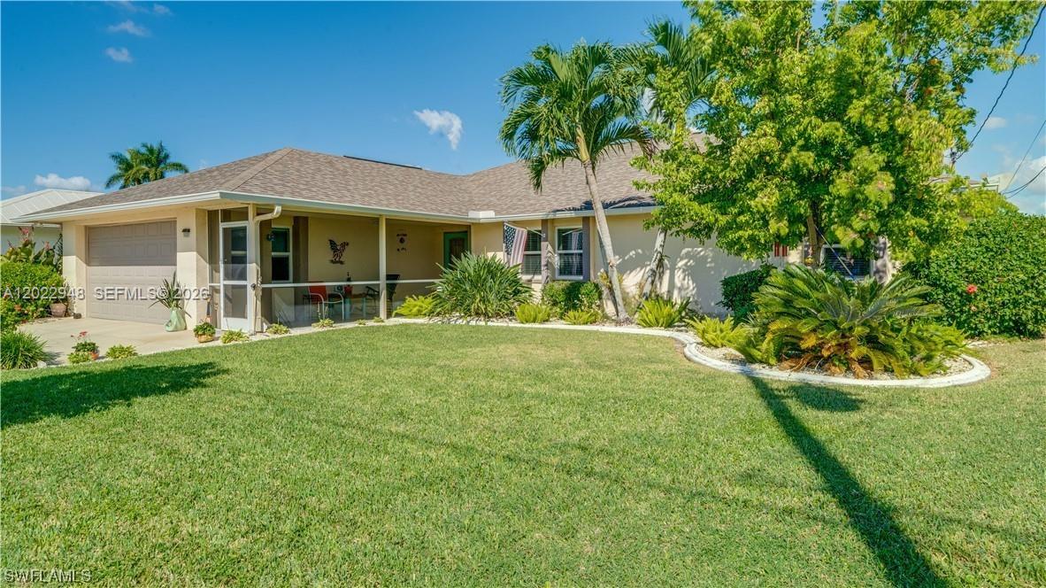 A single-story house with a tan exterior, a covered porch, and a manicured lawn — 503 SW 17 St, Cape Coral FL 33990, CAPE CORAL, FL