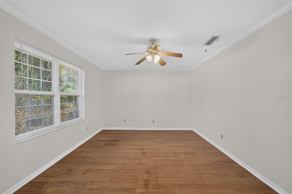 An empty room with light gray walls, wood-look flooring, and a ceiling fan — 2051 DYAN WAY, MAITLAND, FL