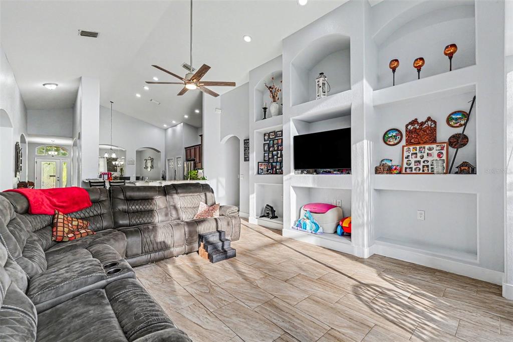 A dining area with a wooden table sits in front of a kitchen with cherry cabinets — 12515 BURGESS HILL DRIVE, RIVERVIEW, FL