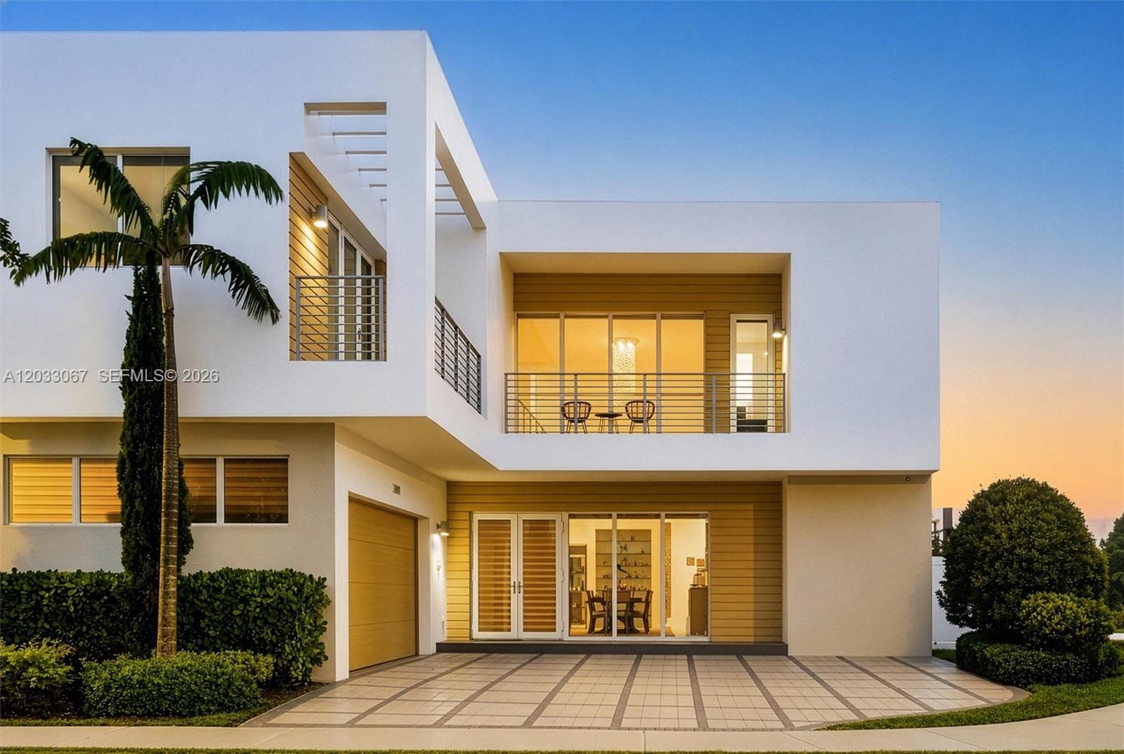 A modern two-story house features white exterior walls, wood-paneled accents, and a paved driveway — 7472 NW 100th Ave, Doral FL 33178, DORAL, FL