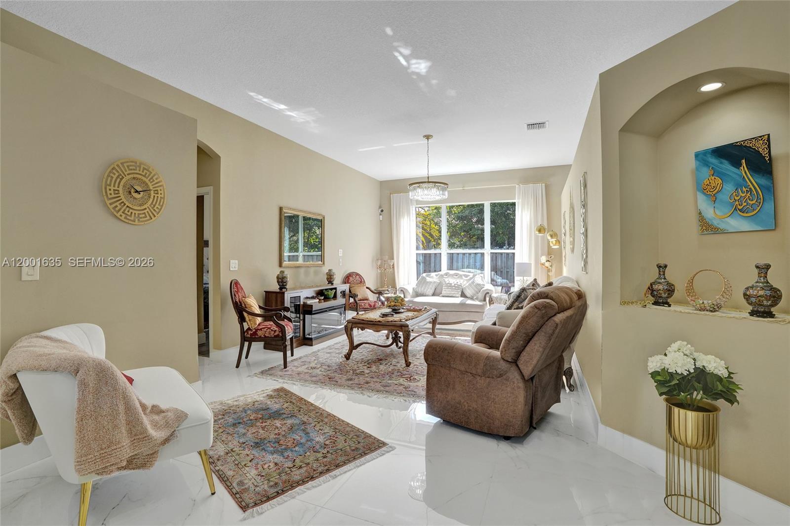 A living room features white tile floors, neutral walls, a chandelier, and assorted traditional furniture — 4286 NW 42nd Ter, Coconut Creek FL 33073, COCONUT CREEK, FL