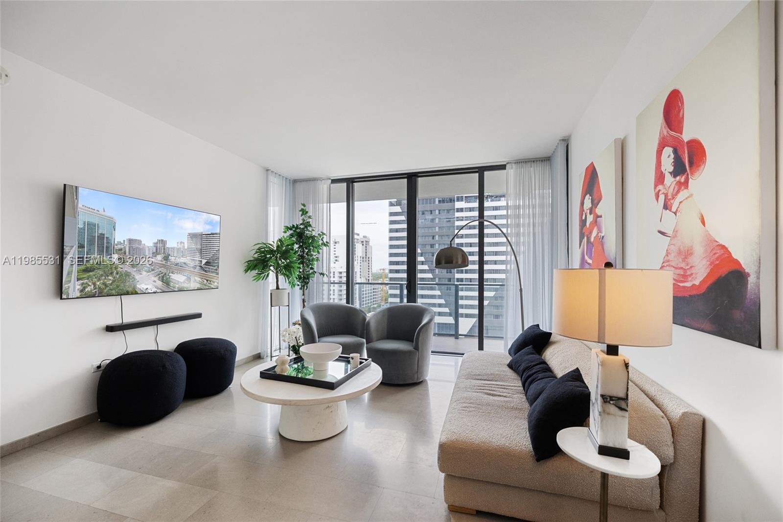 A modern living room features a sofa, two armchairs, a coffee table, and city views — 88 SW 7th St # 1010, Miami FL 33130, MIAMI, FL