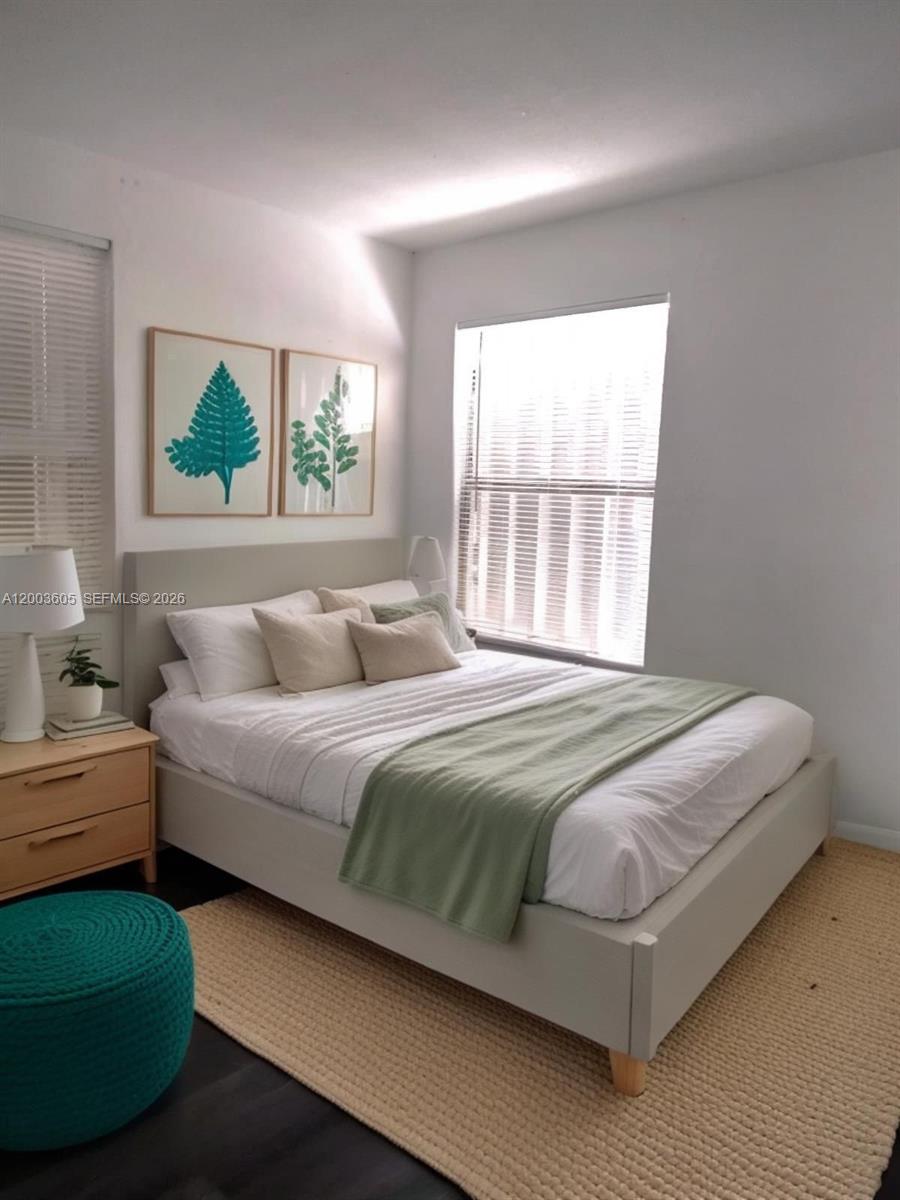 A bedroom features a light gray bed, green accents, and two framed fern prints — 2971 NW 132nd Ter # B, Opa-Locka FL 33054, OPA-LOCKA, FL