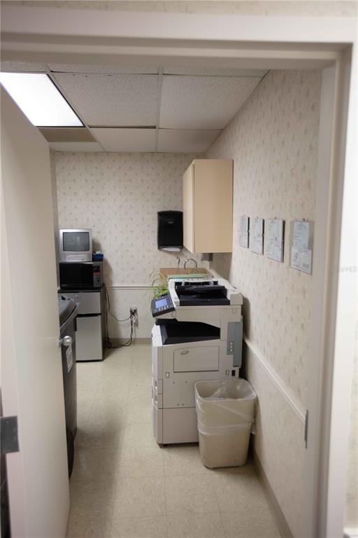 A small office utility room contains a large printer, a microwave, and a mini refrigerator — 1201 FIFTH AVENUE N UNIT 302, ST PETERSBURG, FL