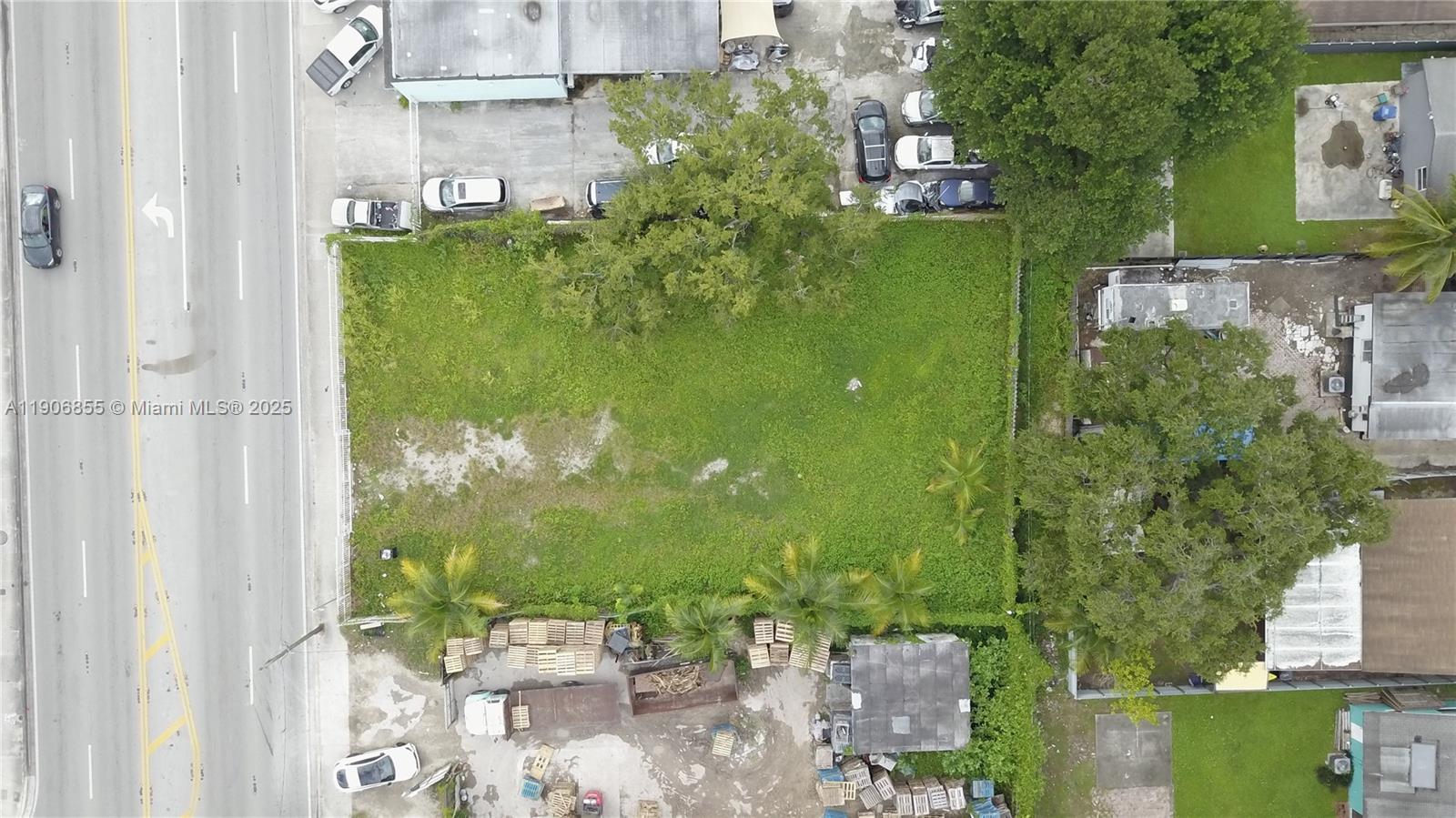 An aerial view shows a rectangular vacant lot bordered by a road and neighboring properties — 3039 NW 54th St, Miami FL 33142, MIAMI, FL